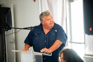 a man speaking at the podium at the event