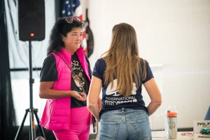 2 women talking to each other at an event