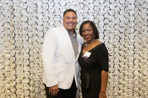 2 people smiling.
