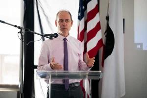 a man speaking at the podium at the event