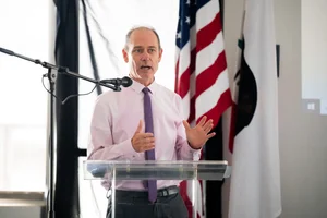 a man speaking at the podium at the event