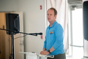 a man speaking at the podium at the event