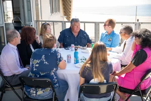 a group of people sitting at a table outside