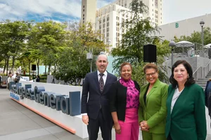 Supervisor Solis group photo in front of E Los Angeles General sign