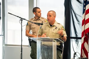officers speaking at a podium