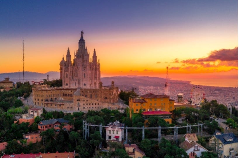The Template of the Sacred Heart of Jesus stands out against the sunset in Barcelona