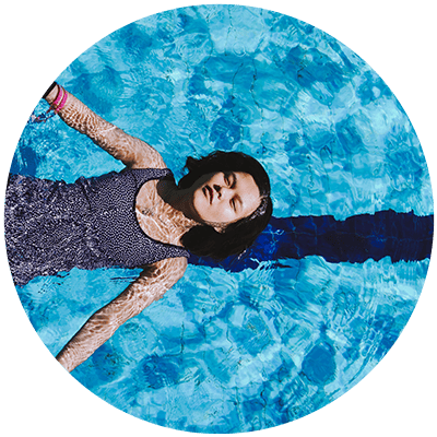 a person face up swimming in the water to show that why leadership development fails is when a "sink or swim" strategy is adopted