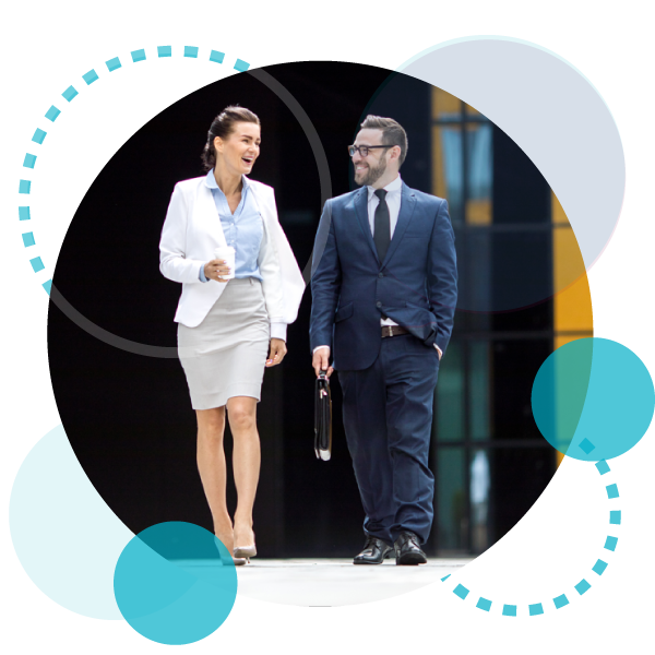 two business professionals talking together with smiles on their faces as they walk?fm=webp&q=65