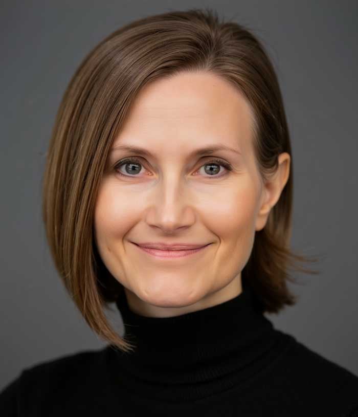 Miranda Orr, a woman with straight brown hair, wears a black turtleneck.