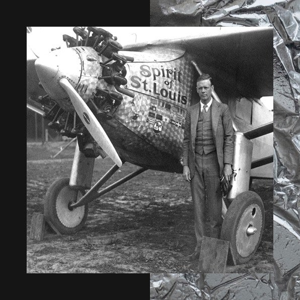 Man next to Spirit of St. Louis airplane