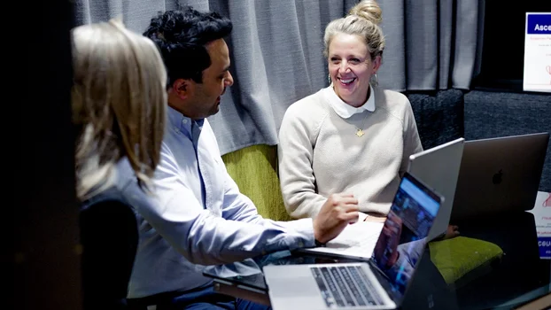 Leah and team members having a coversation