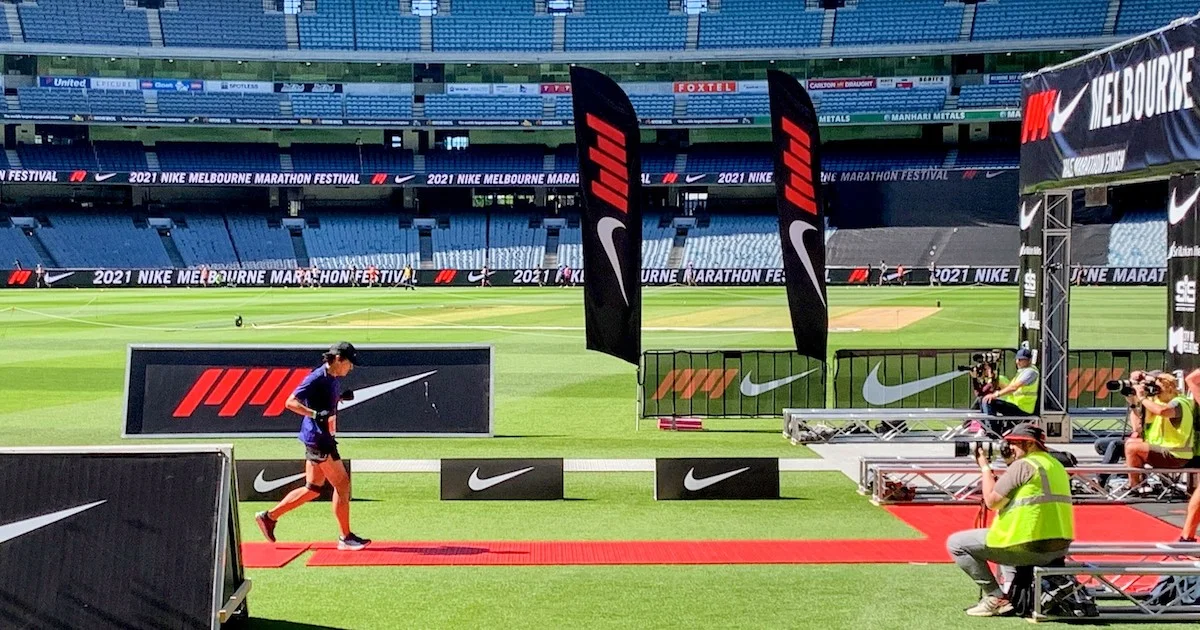 Former ‘non-runner’ Tony Duan crossing the line at the Melbourne Marathon in 2021. 