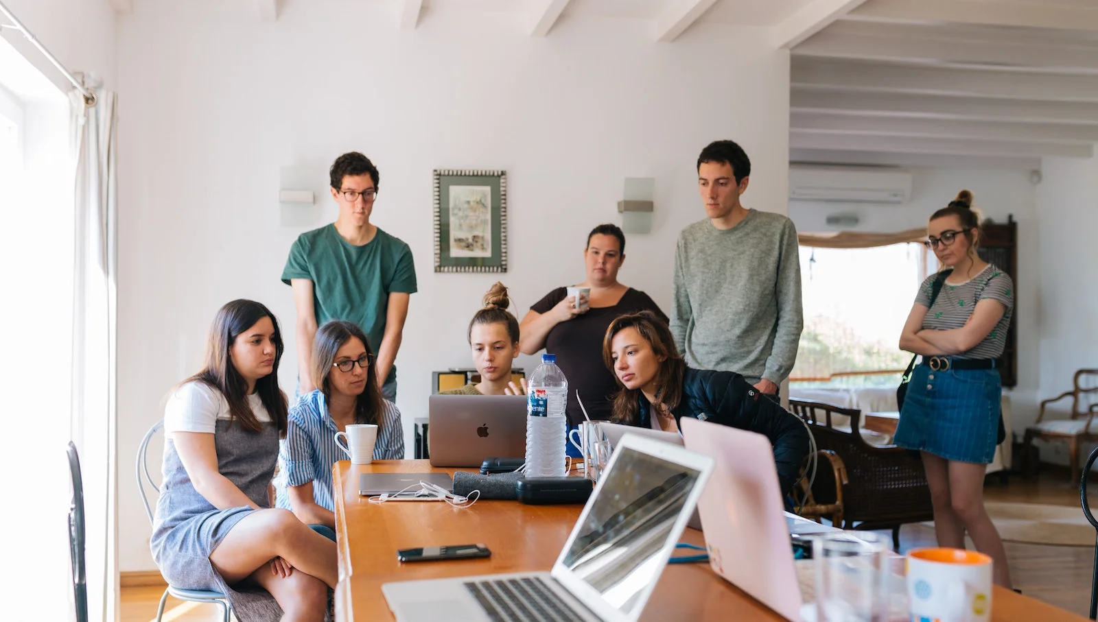 People standing around a computer
