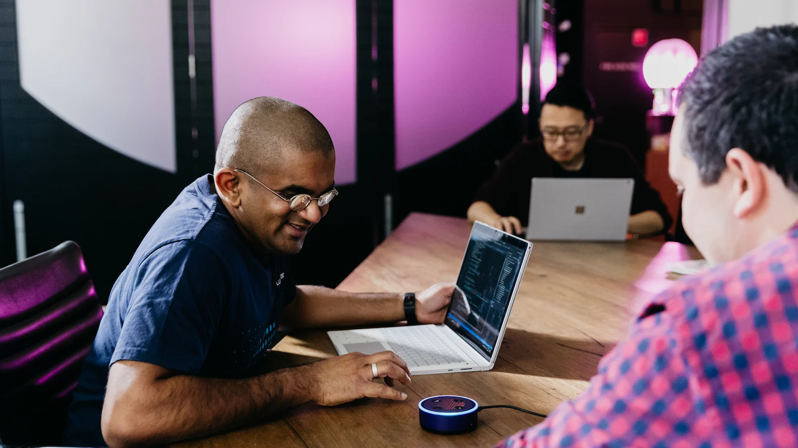 Luminary Tech Lead Emmanuel Tissera working on laptop with Raddo and Tony