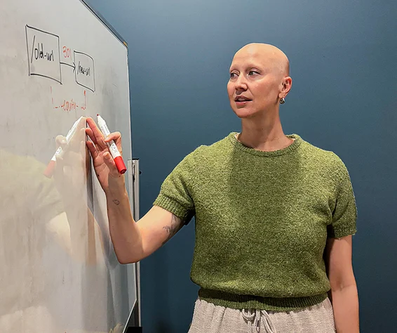 women explaining something on white board