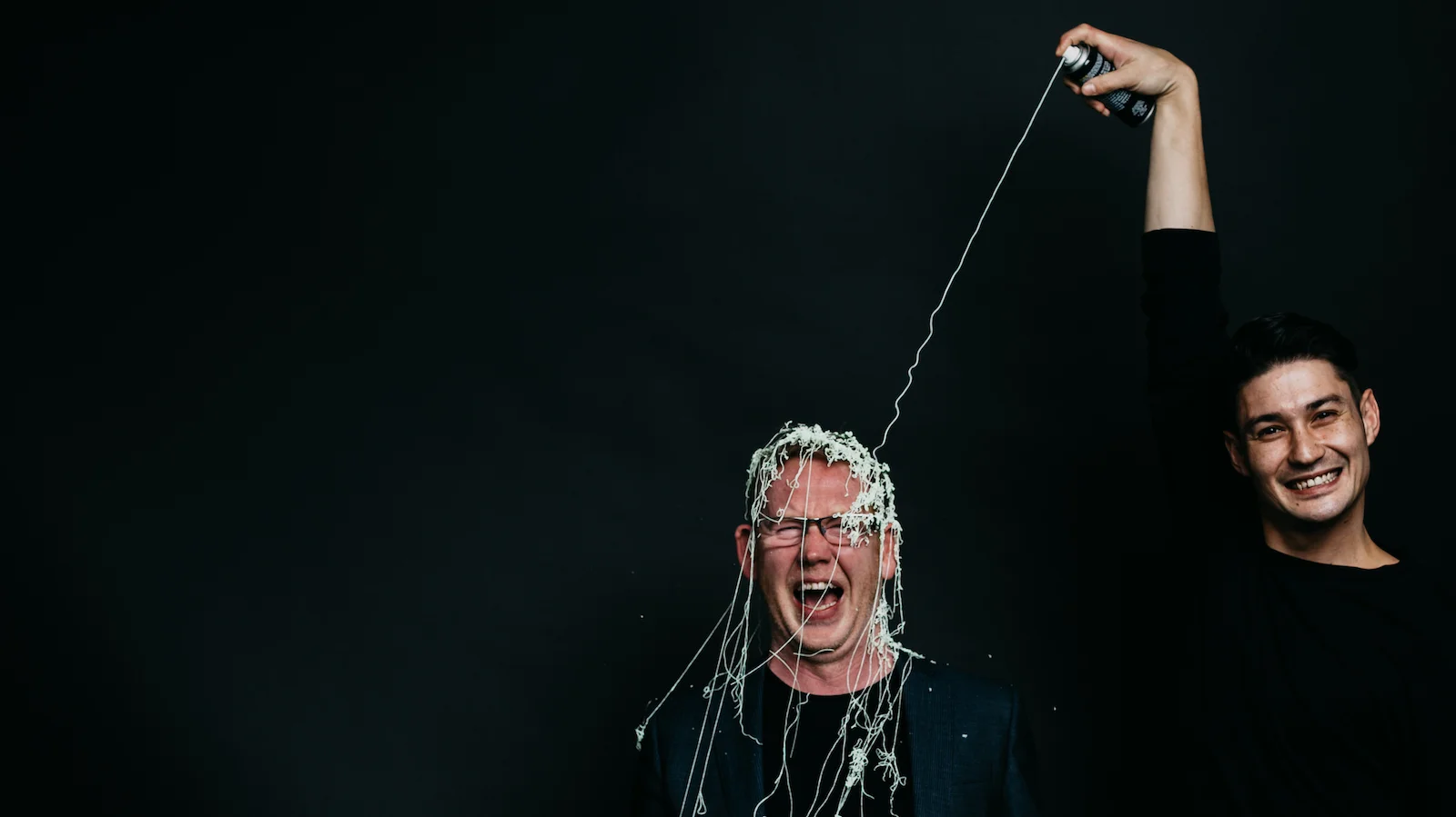Marty and Chey with silly string and the Best Places to Work logo