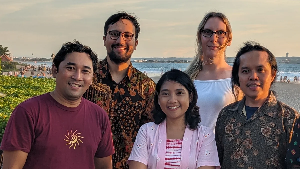 Picture of the Bali team on a team night against the backdrop of the beach