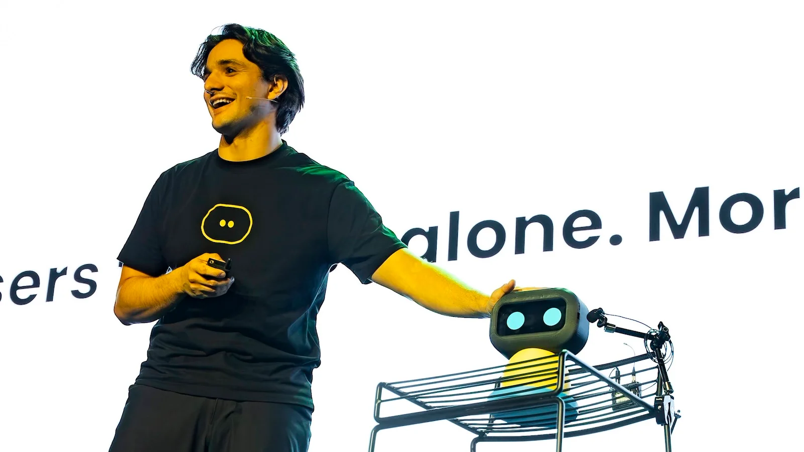 Picture of William Cerdelli, YAA finalist, on stage talking about his AI robot, STU