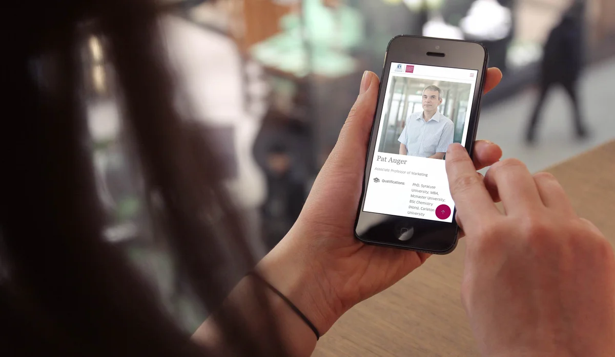 MBS website displayed on a mobile phone being held by a person