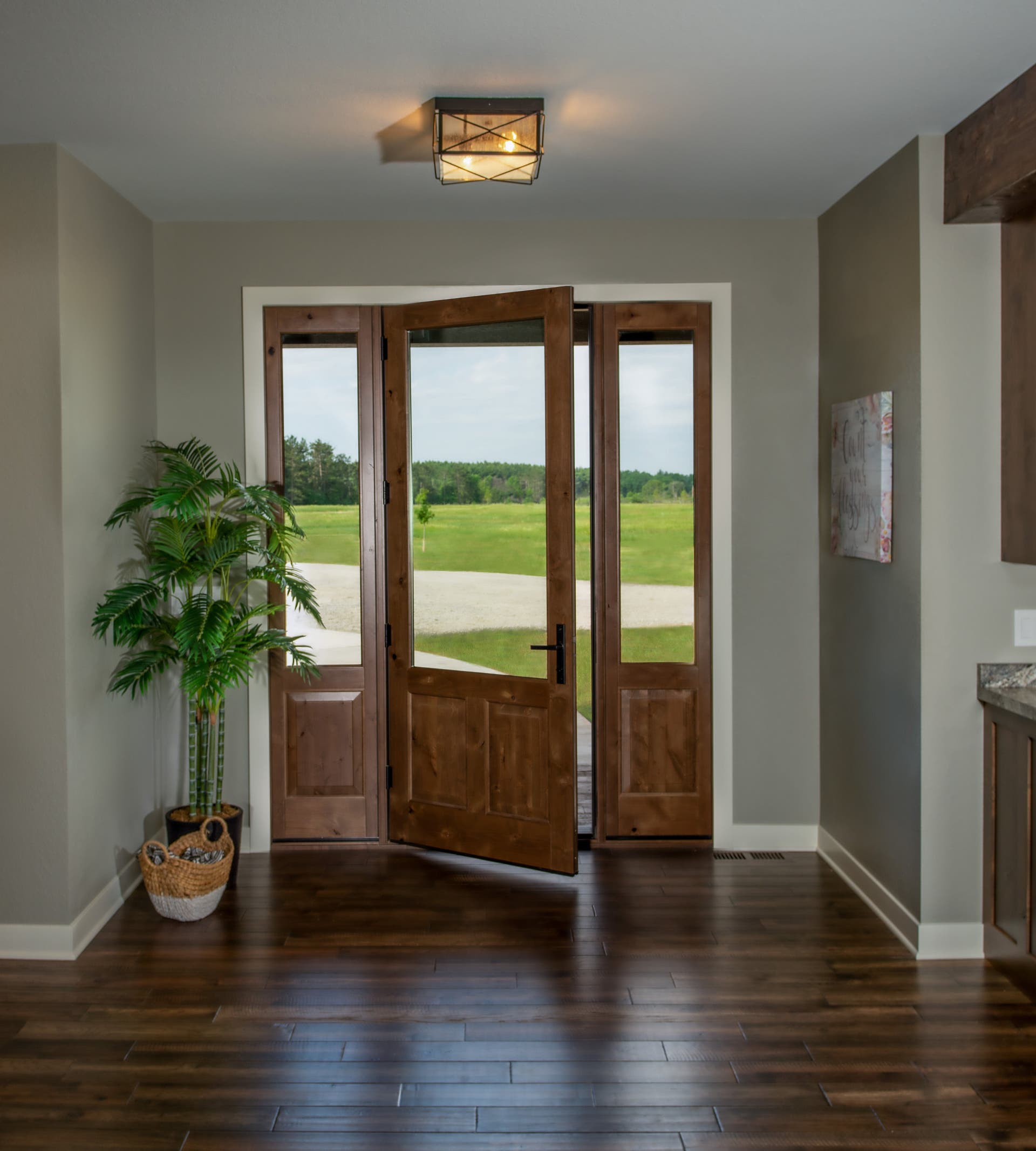 Ultra Series inswing door with raised panels and sidelites, Knotty Alder wood interior, double clear coat finish, Dallas hardware in Matte Black