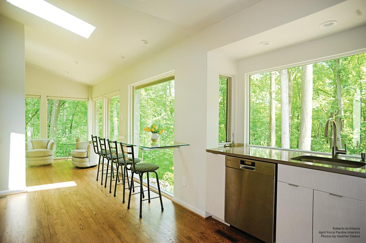 A kitchen with a table and chairs