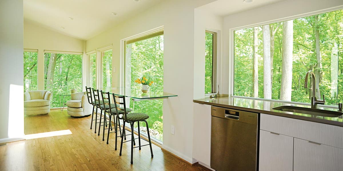 A kitchen with a table and chairs
