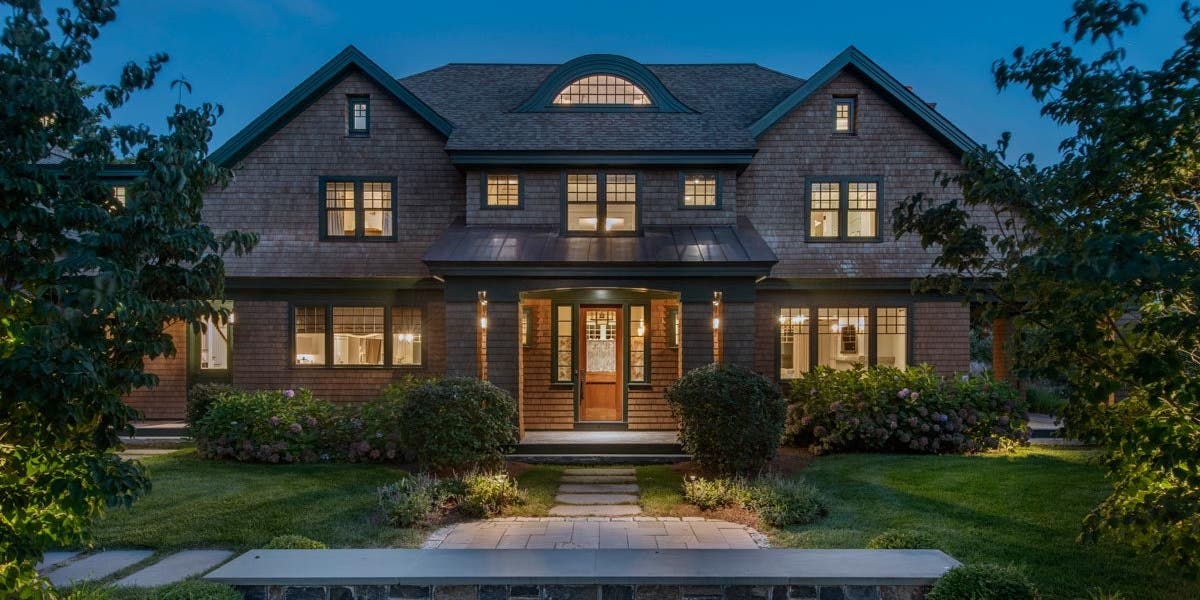 A house with Heritage Series awnings, casements, direct sets, double-hungs, transom, and swing door with a stone walkway