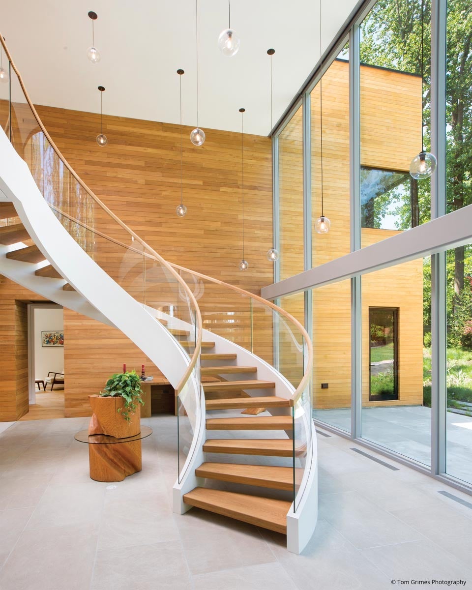 AN106 - spiral staircase next to two story window wall