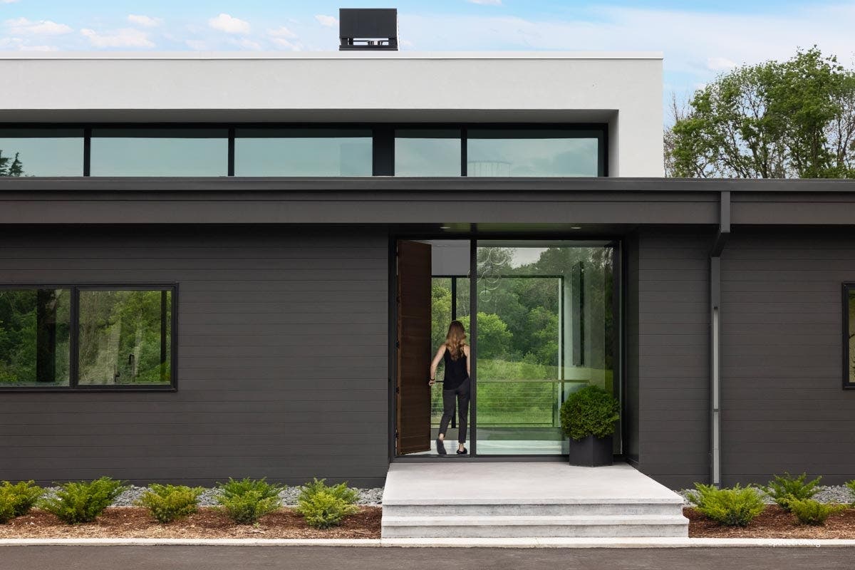 exterior view of women walking into home with VistaLuxe windows and doors