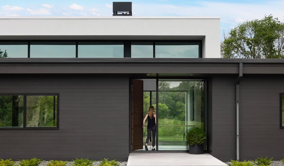 exterior view of women walking into home with VistaLuxe windows and doors