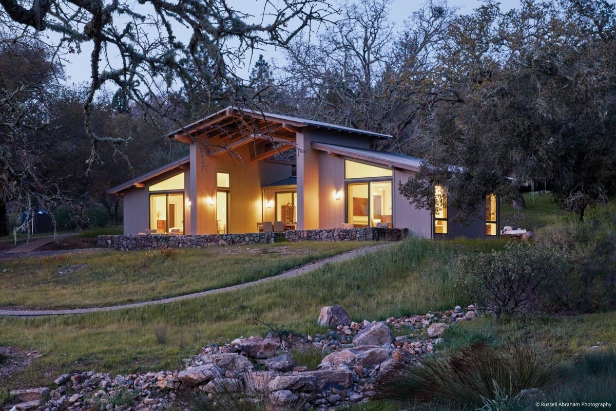 AM215 - rear view of guest house at night with VistaLuxe WD geometric direct sets over sliding doors