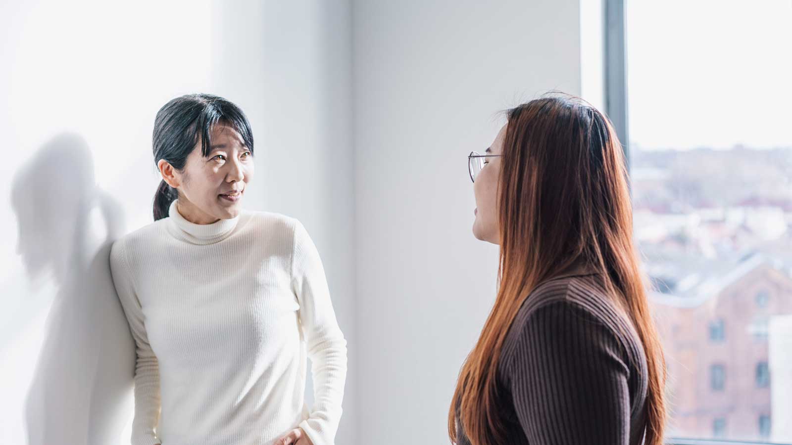 A student and tutor talking on campus