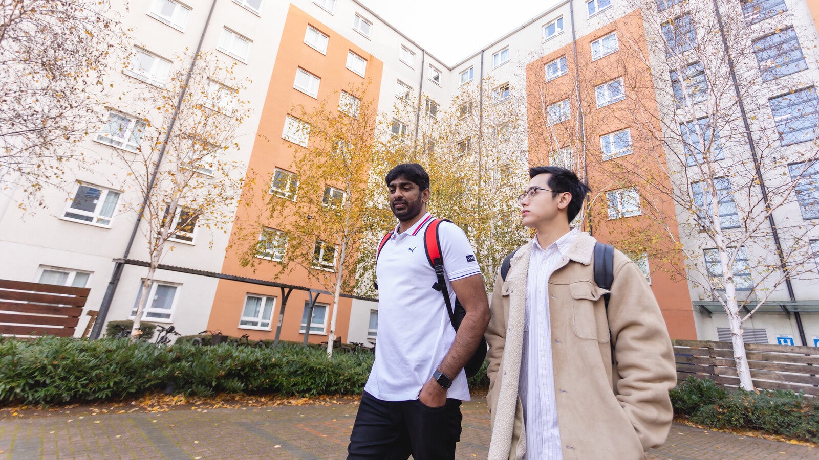 Two students walking outside campus