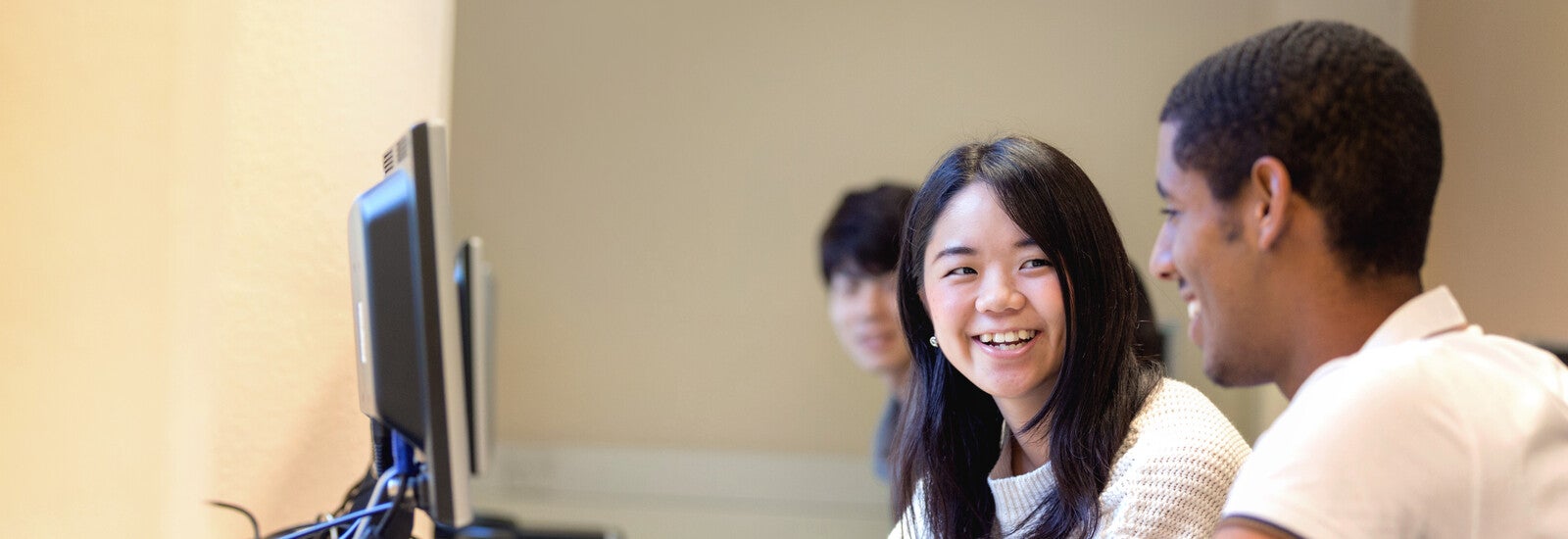 Two students using a desktop computer