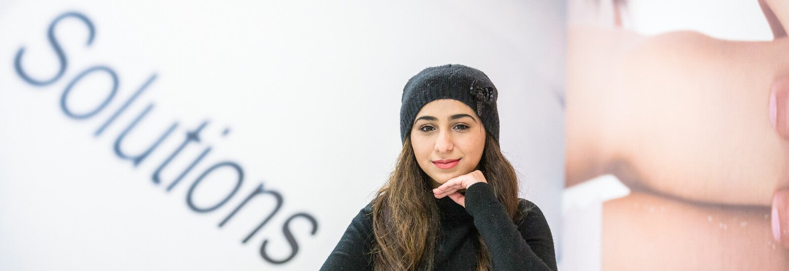 A student in front of an inspirational wall.
