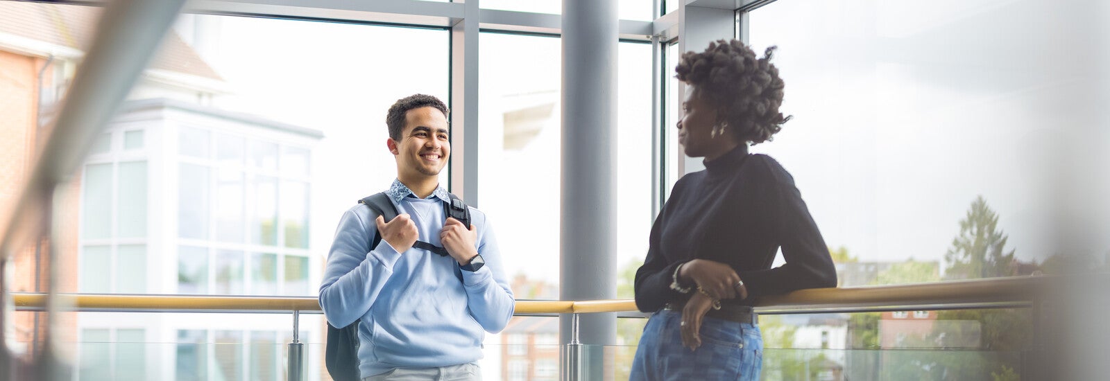 Two students on a glassy balcony in Leeds ISC.