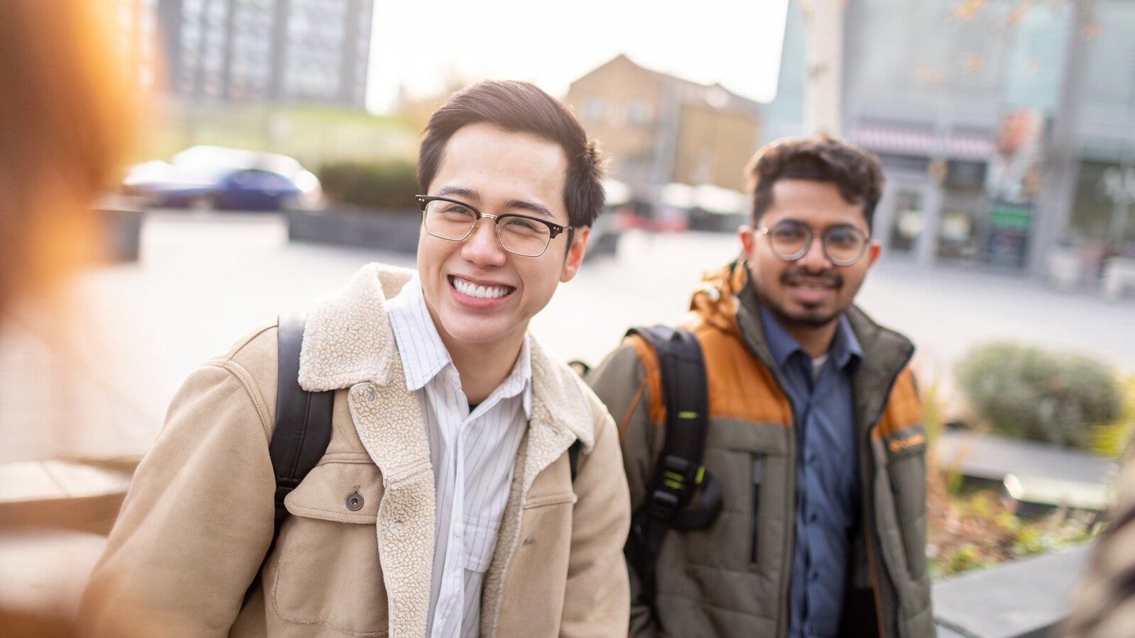 Two students smiling outside campus