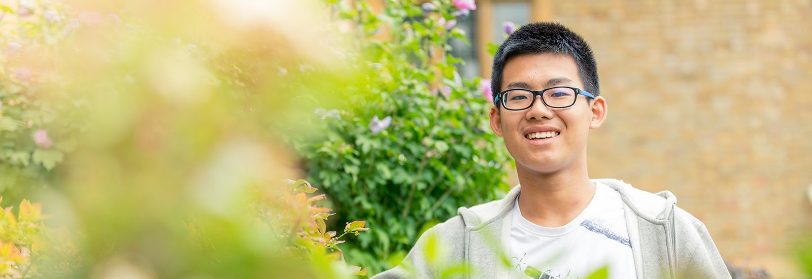Student smiling outside campus