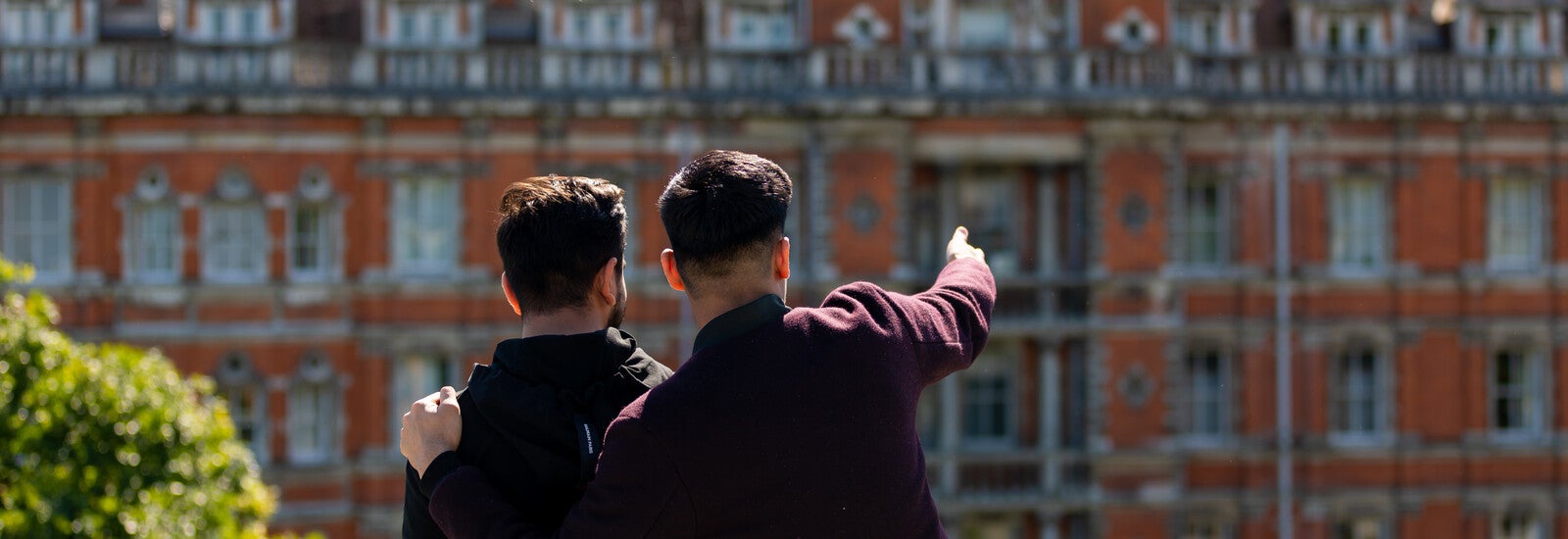 Two students looking at the buildings on campus