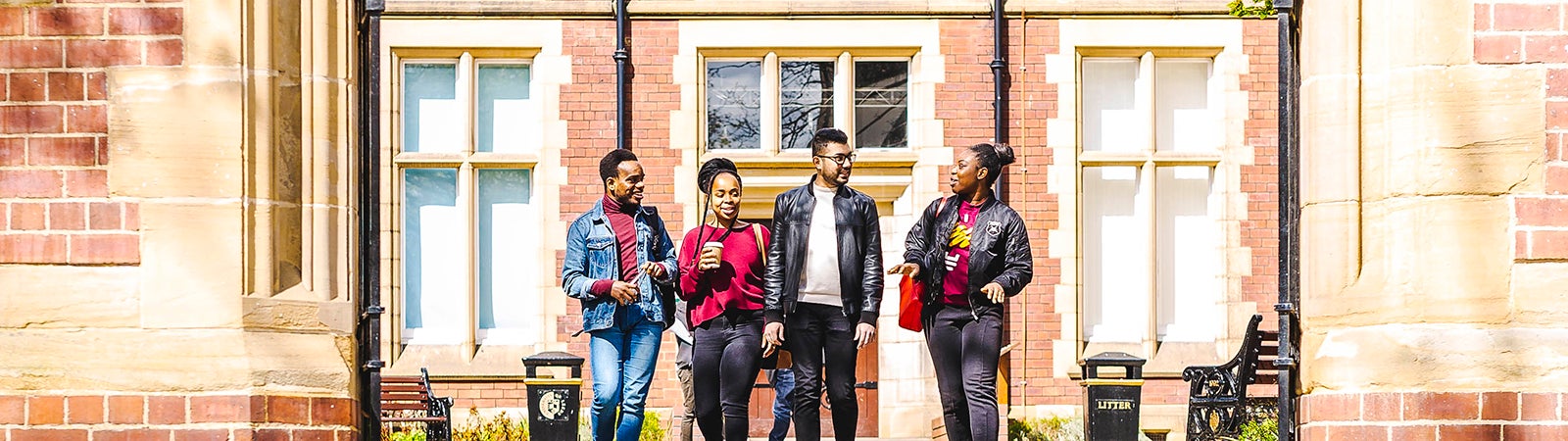 Four students walking on campus