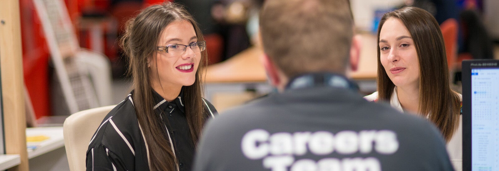 Two students sitting with a career advisor