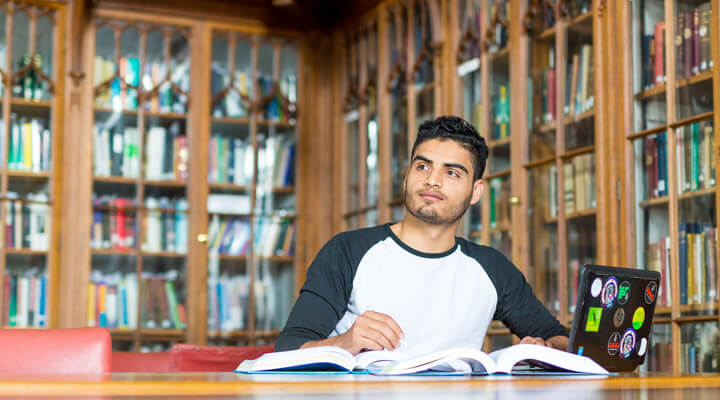 Student sitting at a desk with a laptop