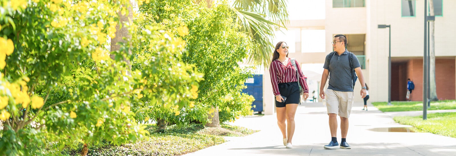 Two students walking together outside campus
