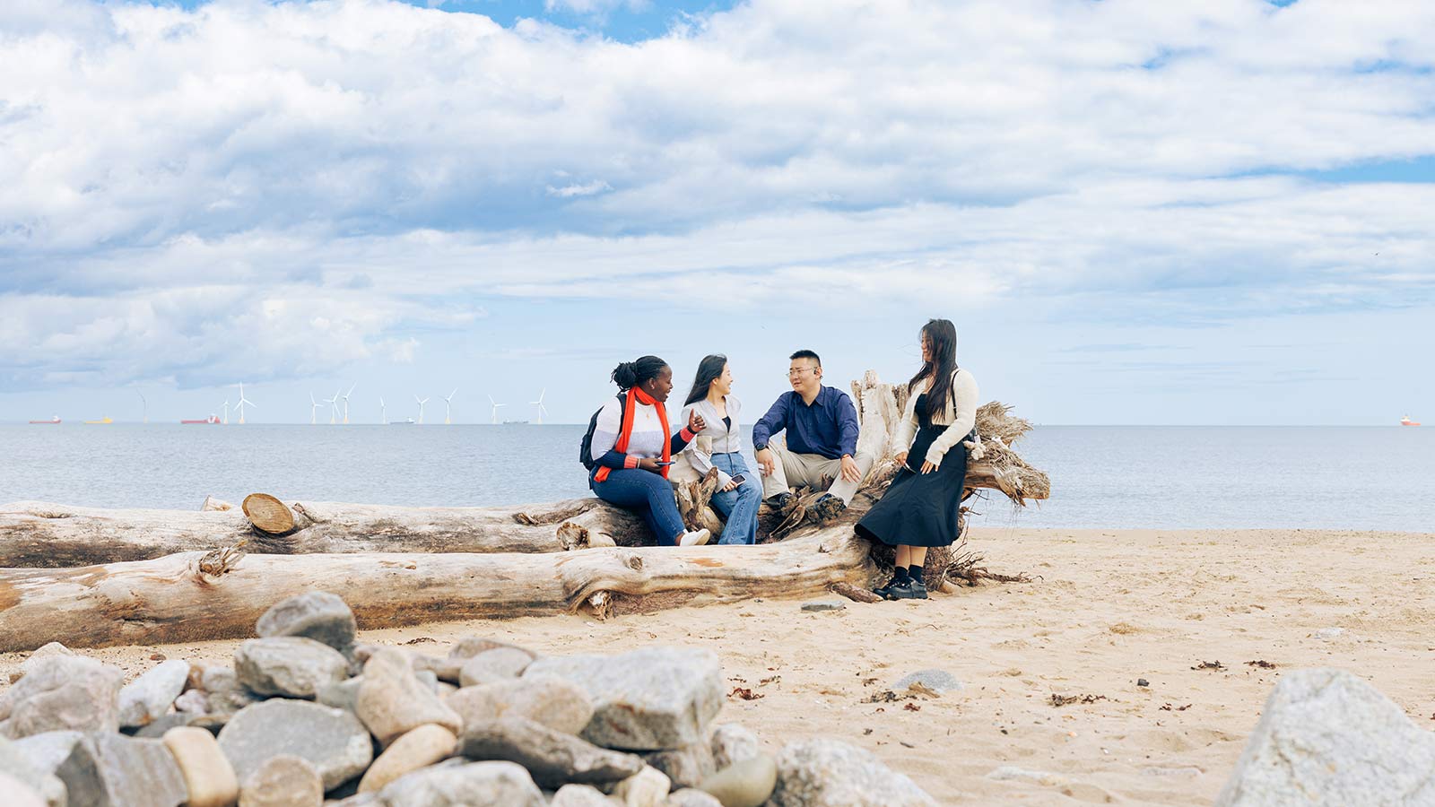 A group of students sitting on a beach