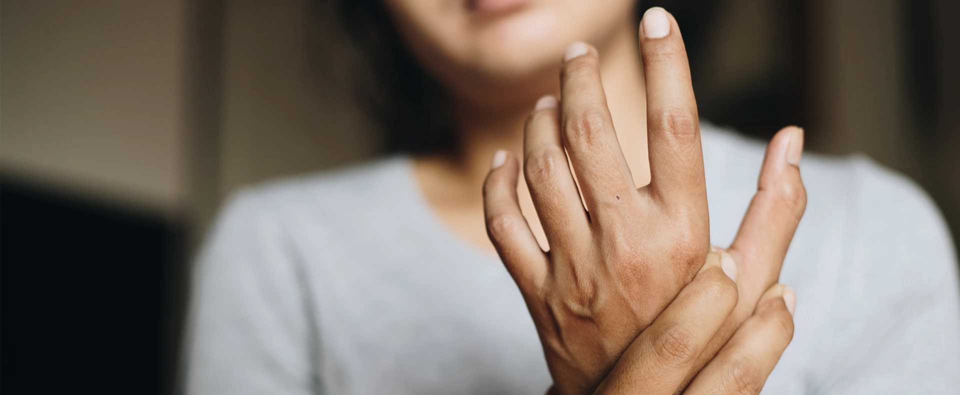 Woman gently gripping her wrist
