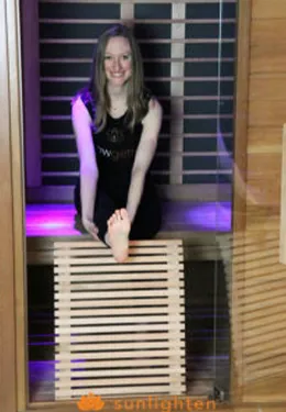 Seated leg stretch in sauna