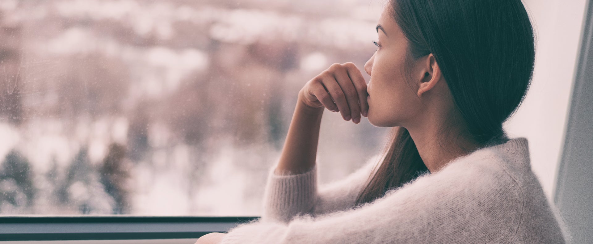 Girl sitting down looking out the window