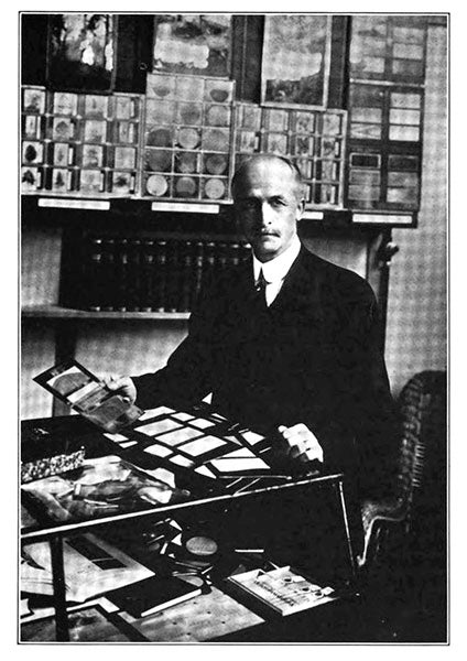 Romeyn Beck Hough in a publicity photograph, with cards from American Woods, various business cards made of wood, as well as lantern slides, and microscope slides, California’s Magazine, 1916 (microscopist.net)