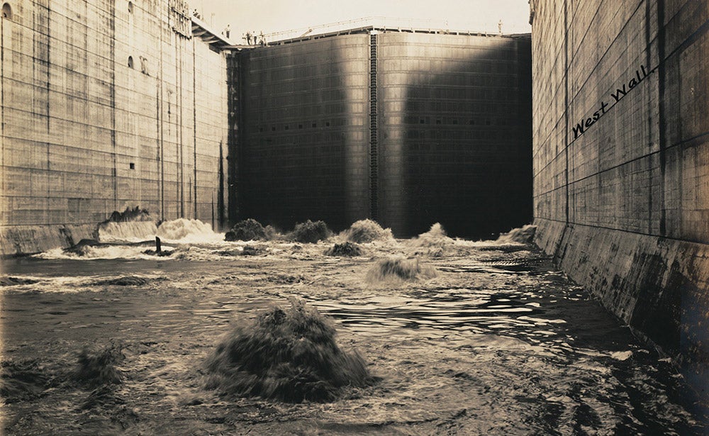 First water entering Miraflores upper lock, October 14, 1913.
A Canal lock chamber can fill with water in eight minutes. To raise a ship, fresh water is pumped via gravity through culverts that were built into the side and center walls of the locks. The culverts send water into chambers through holes in the floors. 