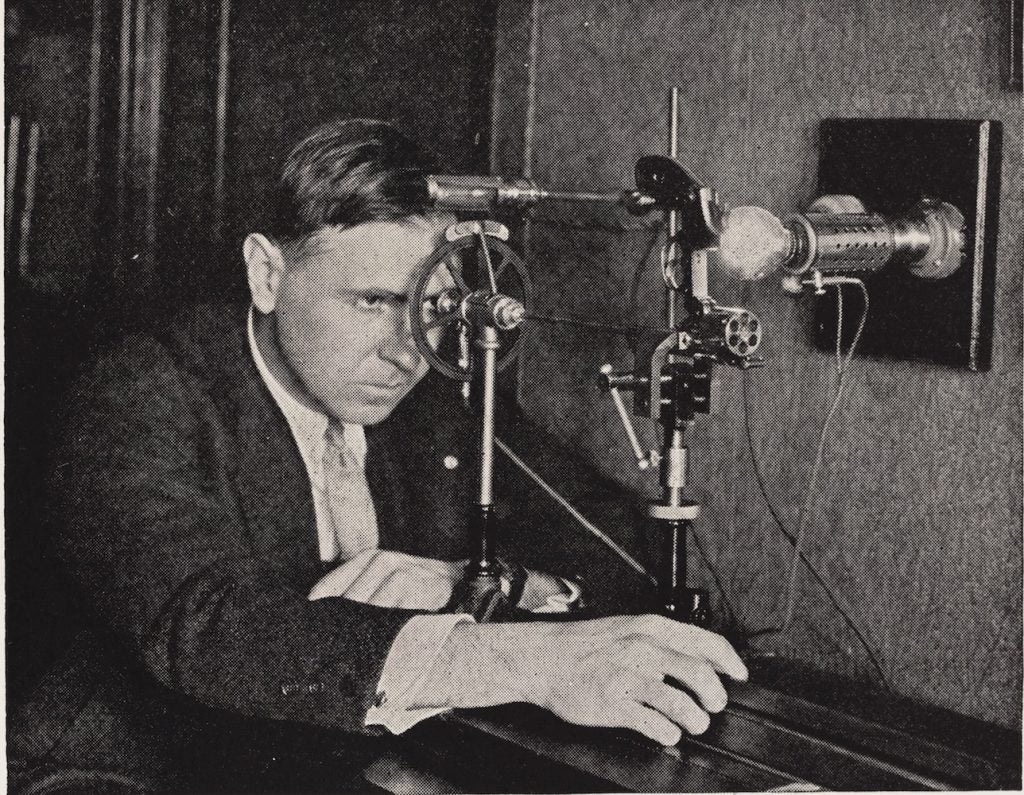 Calvin Goddard examining examines a revolver using a helixometer, an instrument he co-invented with colleague, John Fisher. The barrel of each gun has unique helical grooves to spin the bullet that make impressions on the bullet as it passes through the barrel. Image source: The Edison Monthly. New York: New York Edison Co., 1909. View Source